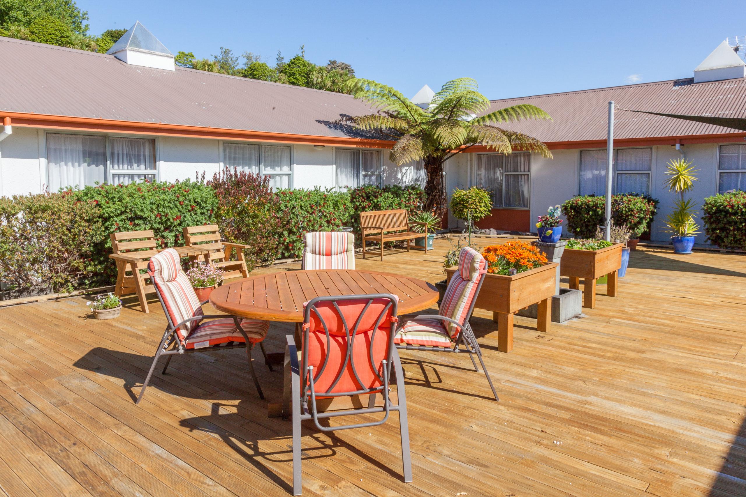 Ohinemuri retirement village and rest home decking area with palm tree
