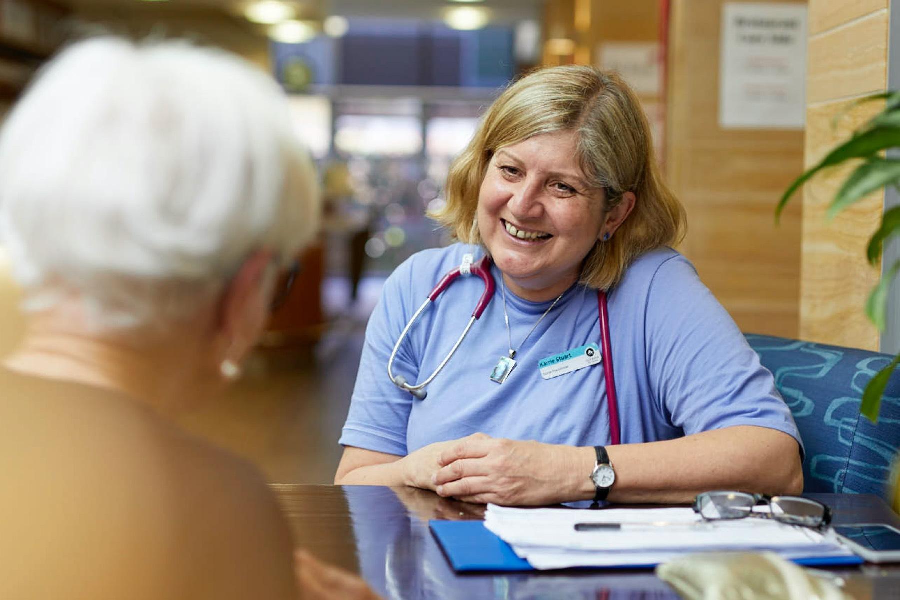Oceania nurse discussing with a resident