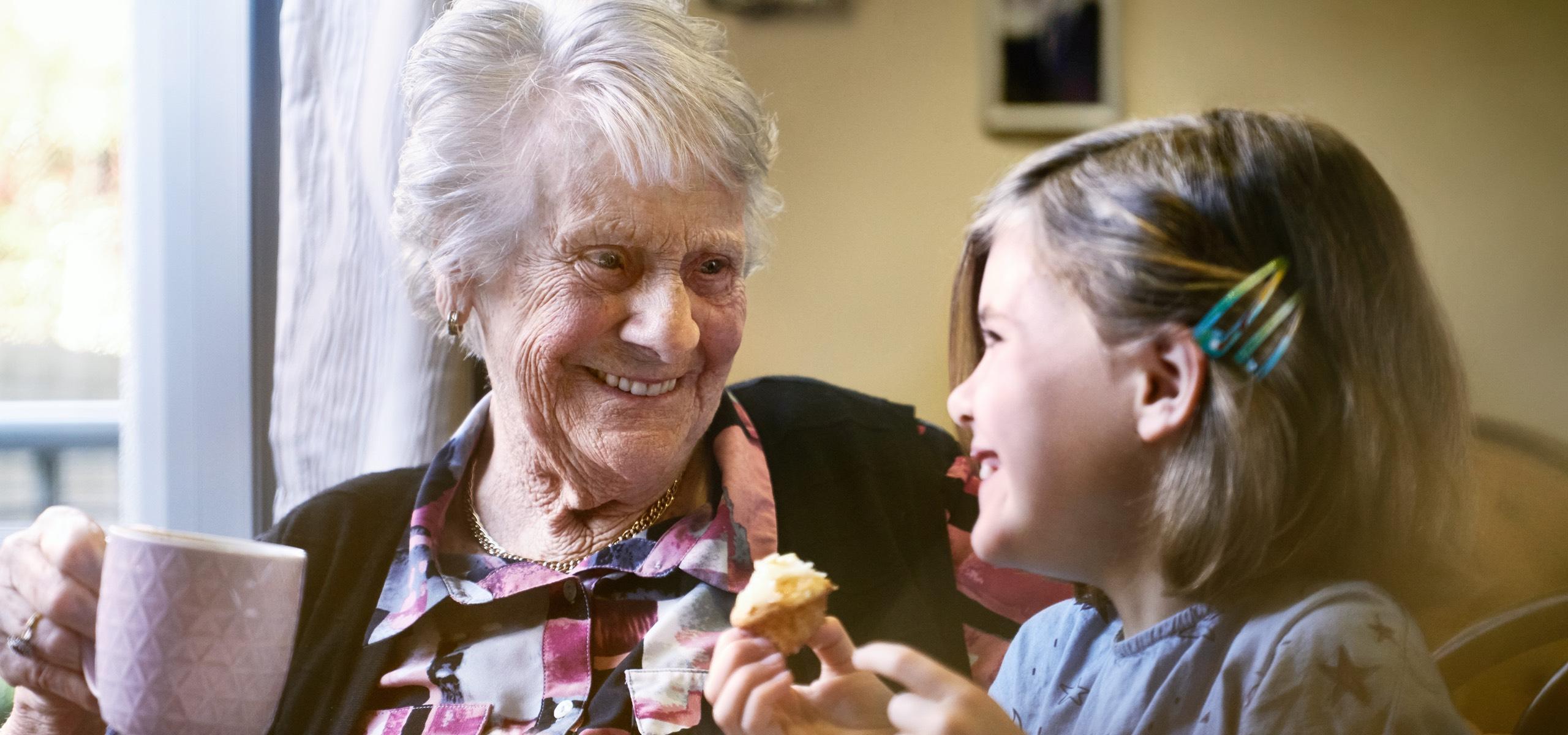 Oceania resident enjoying brunch with a young girl