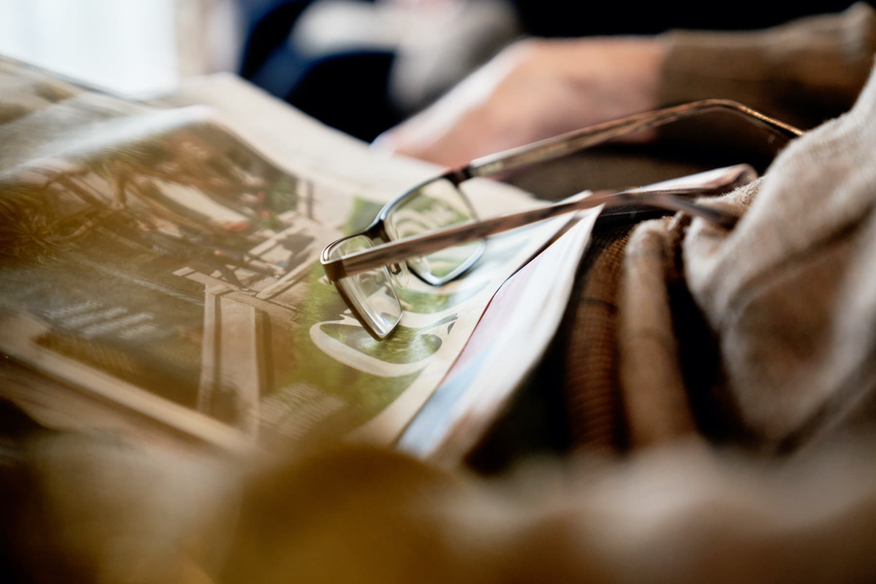 Oceania newspaper and reading glasses