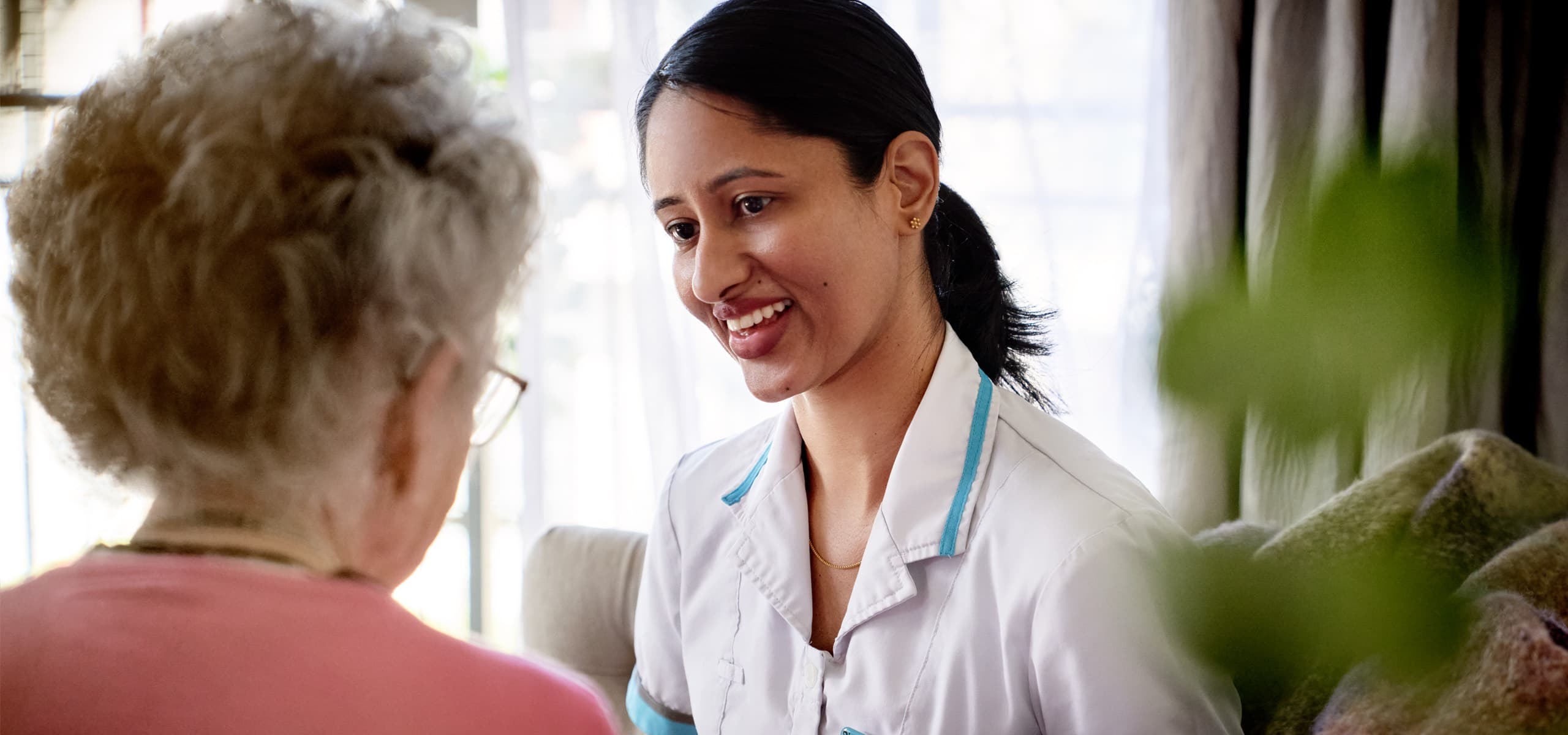 Oceania nurse smiling at resident