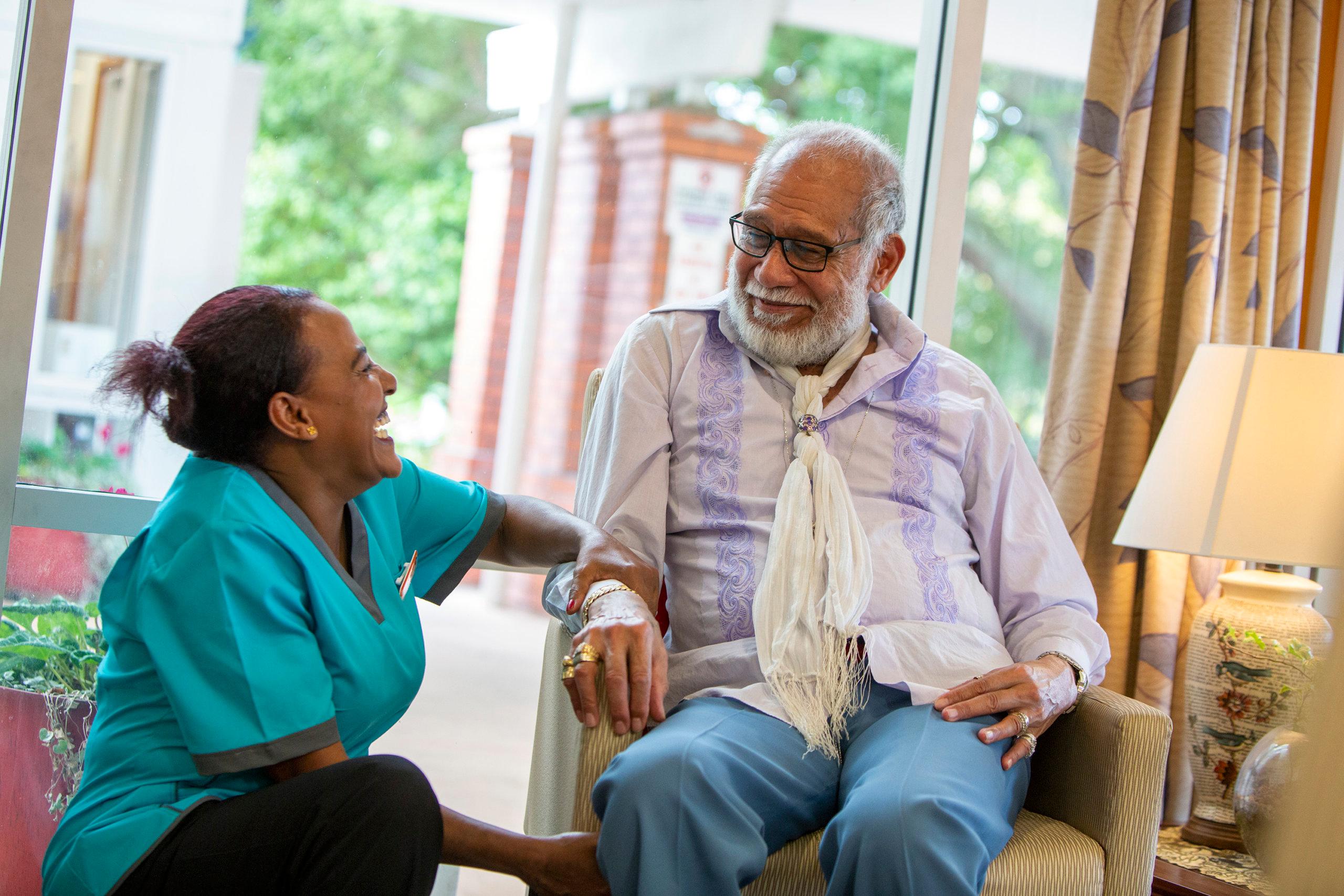 Oceania nurse laughing with a care resident